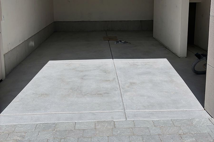 An empty garage with bare concrete before installation
