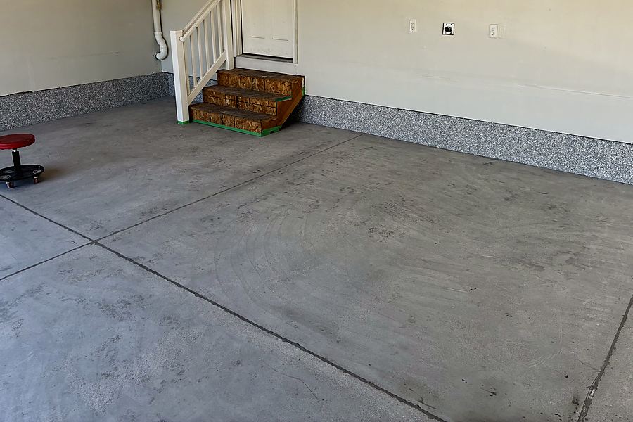 A garage with the coved flake base installed and the concrete floor still bare
