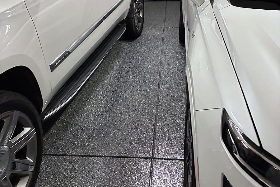 Cars parked on a finished dark flake epoxy garage floor